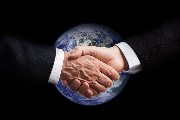 Photo of handshake over globe